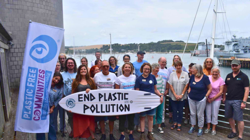 A group of activists holding up an 'end plastic pollution' sign